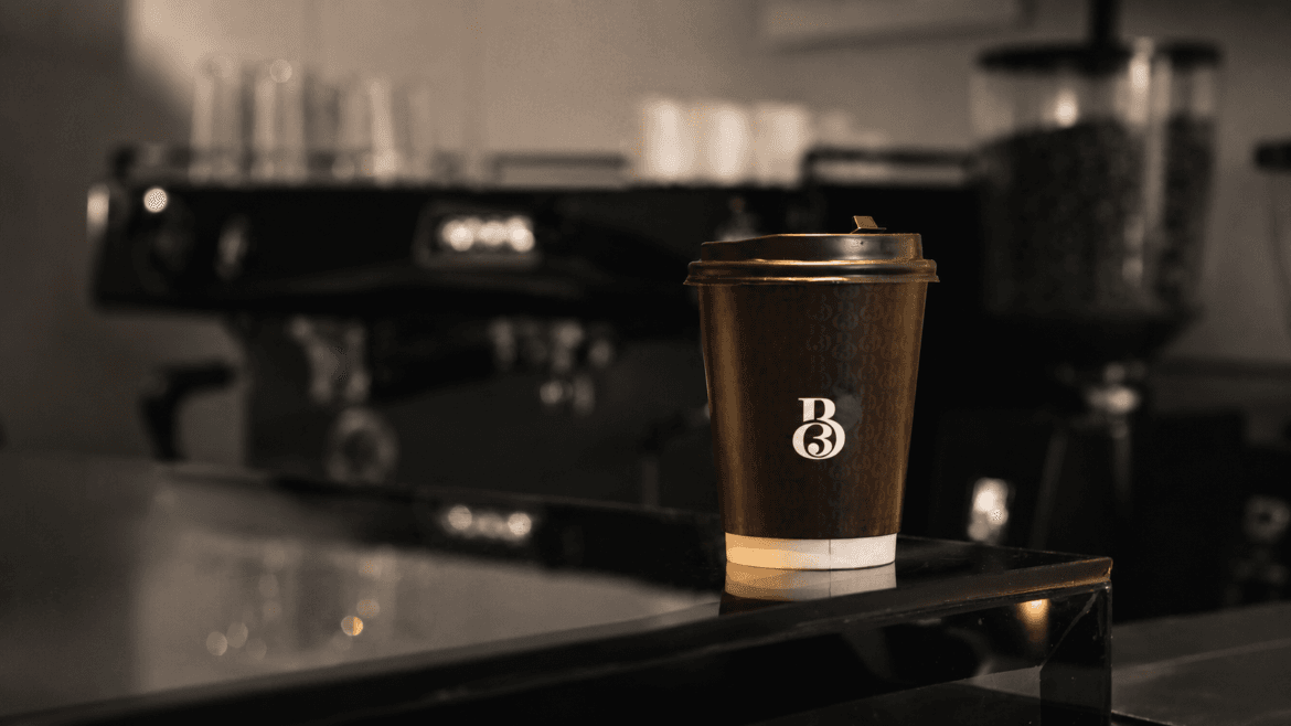 A Bean Brew takeaway cup on the café bar
